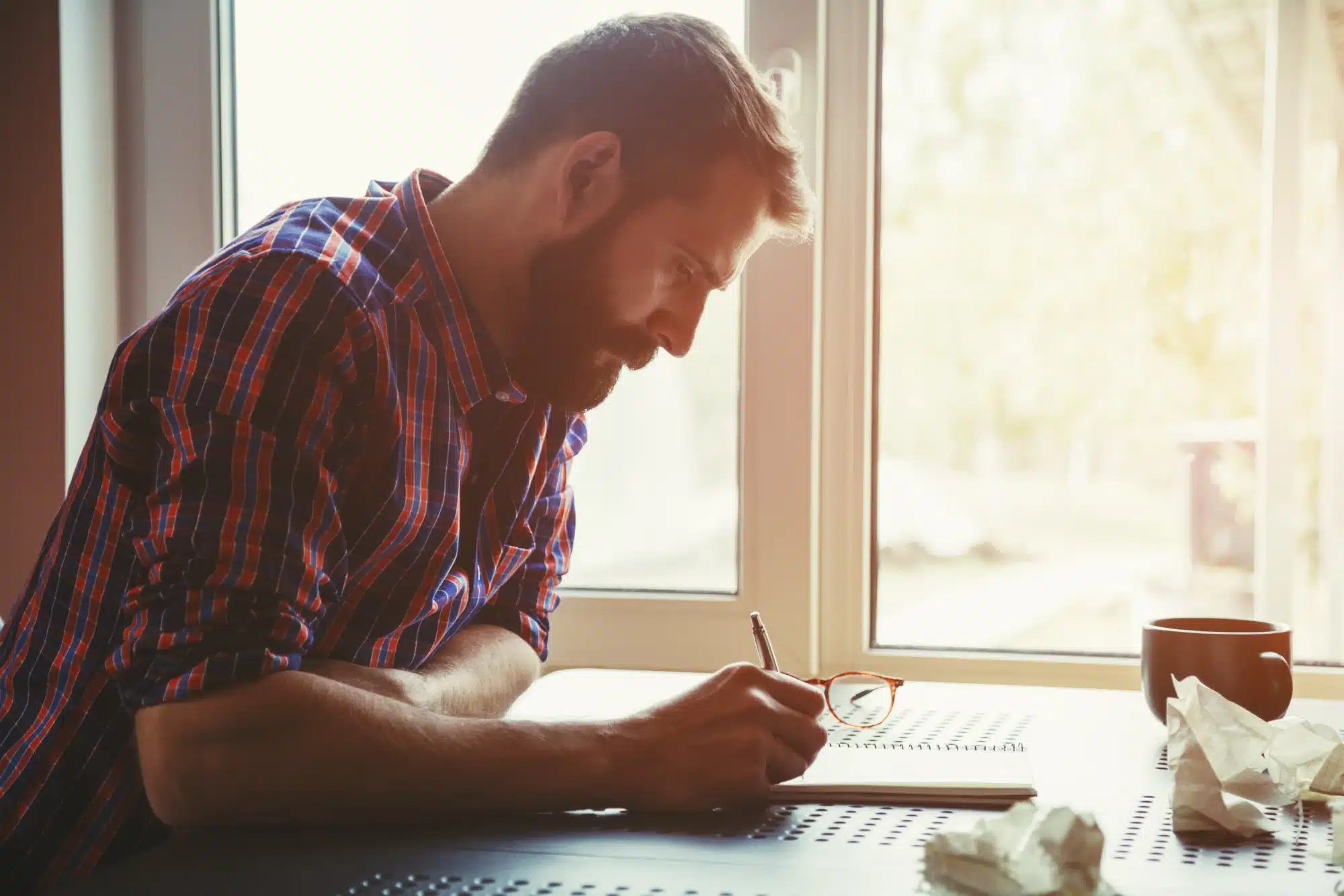Hands filling out a medical leave form with a pen