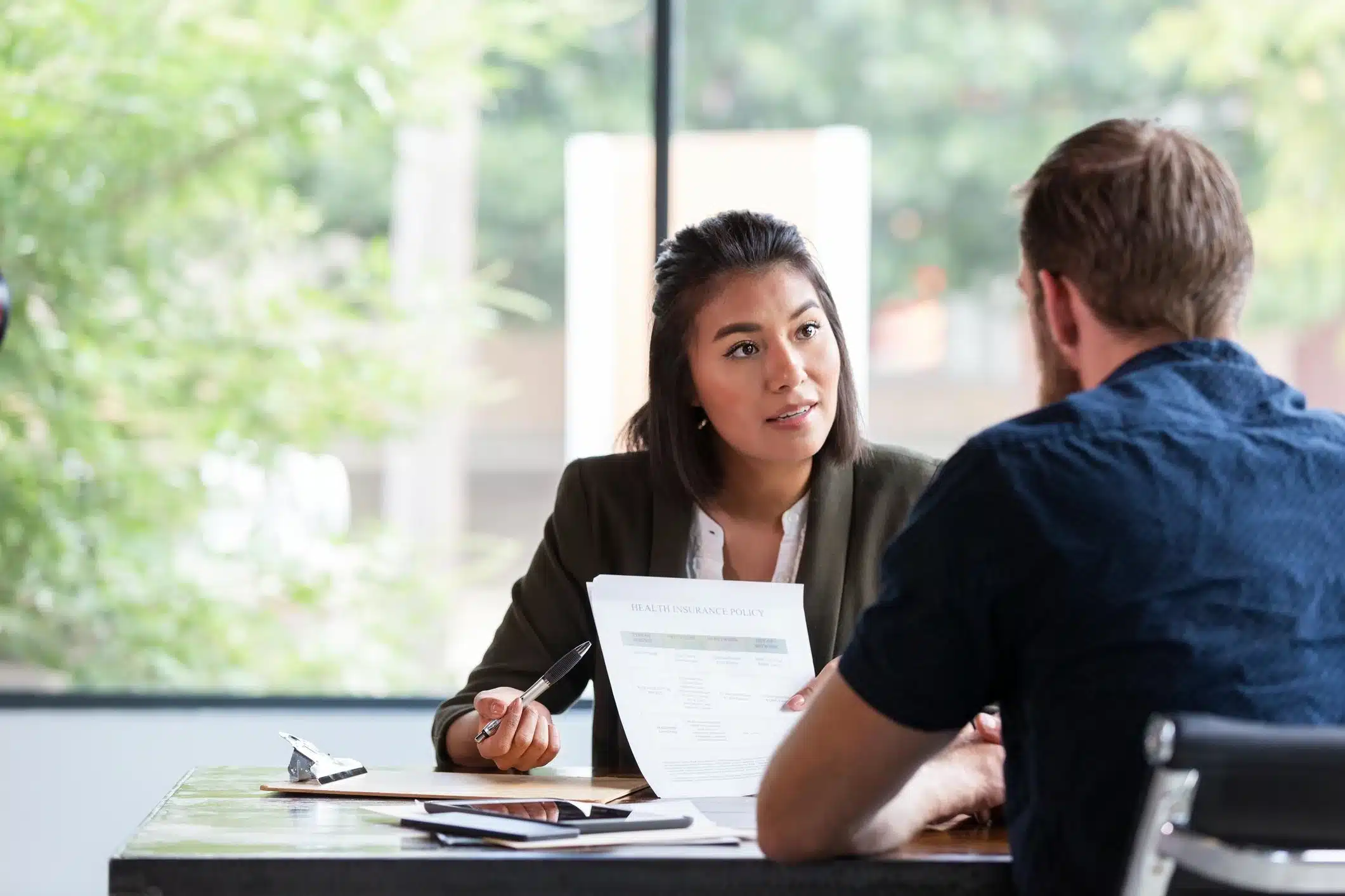 Two professionals in a private conversation in an office